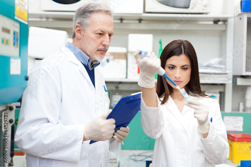 Photo: Couple of scientist researching in a laboratory Couple of scientist researching in a laboratory