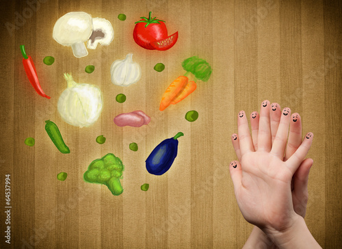 Photo: Happy smiley face fingers looking at illustration of colorful he Happy smiley face fingers looking at illustration of colorful he