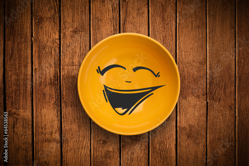 Photo: Happy smiley cartoon face on colorful dish plate Happy smiley cartoon face on colorful dish plate