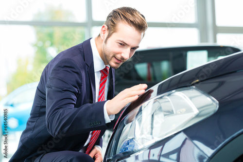 Photo: Verkäufer mit Auto im Autohaus Verkäufer mit Auto im Autohaus