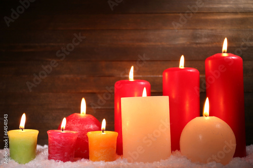 Photo: Burning candles on wooden background Burning candles on wooden background
