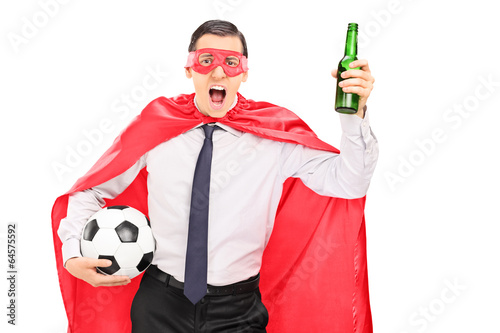 Photo: Superhero holding a football and cheering Superhero holding a football and cheering