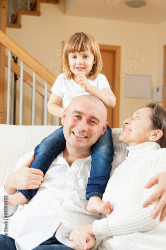 Photo: family sitting on sofa family sitting on sofa