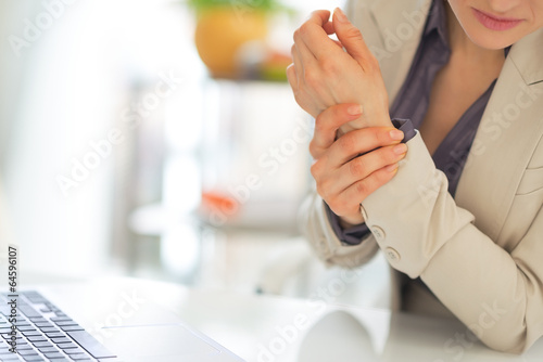 Photo: Closeup on business woman with wrist pain Closeup on business woman with wrist pain