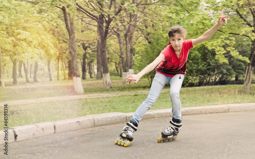 Photo: Attractive teenage girl roller skating at speed Attractive teenage girl roller skating at speed