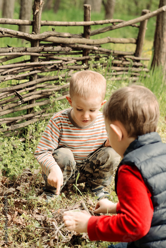 Photo: Two young boys discussing lighting a campfire Two young boys discussing lighting a campfire