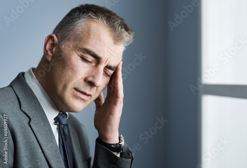 Photo: Stressed businessman with headache Stressed businessman with headache