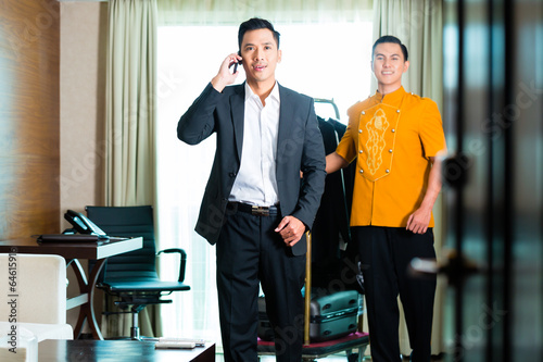 Photo: Asian Guest checking in hotel room Asian Guest checking in hotel room