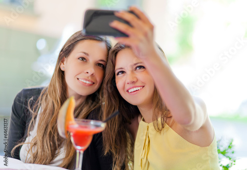 Photo: Selfie girls taking a photo of theirselves Selfie girls taking a photo of theirselves