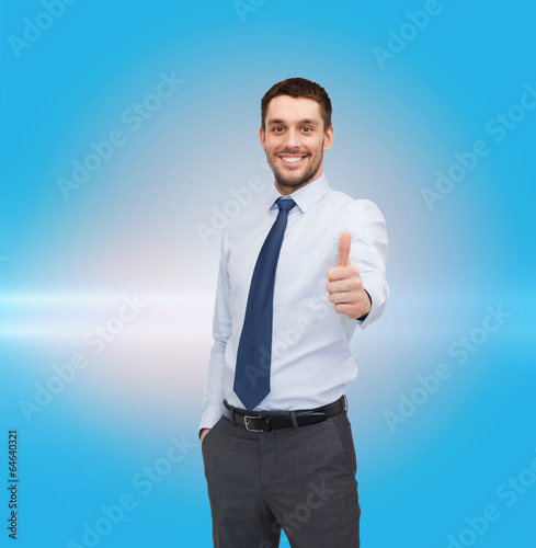 Photo: handsome businessman showing thumbs up handsome businessman showing thumbs up