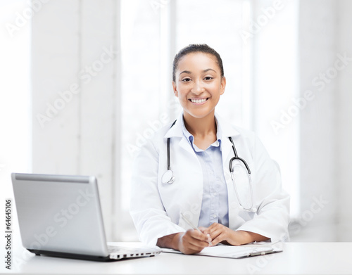 Photo: female doctor with laptop pc female doctor with laptop pc