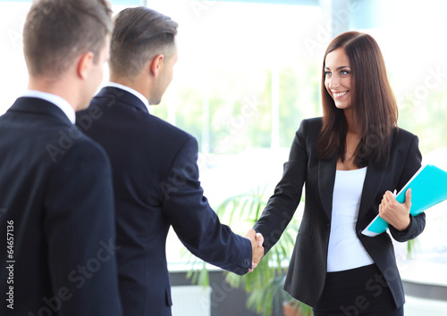 Photo: Business people shaking hands, finishing up a meeting Business people shaking hands, finishing up a meeting