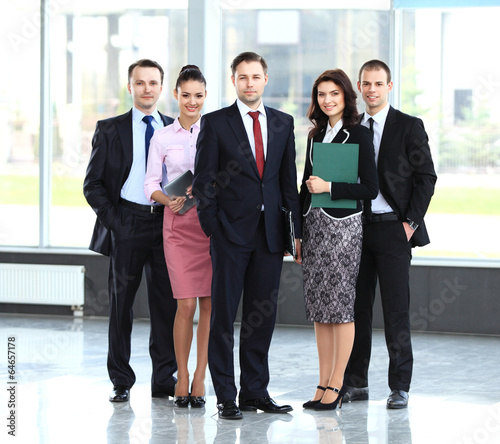 Photo: Group portrait of professional business team looking confidently Group portrait of professional business team looking confidently