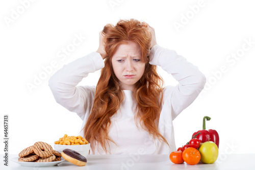 Photo: Girl trying to decide what to eat Girl trying to decide what to eat