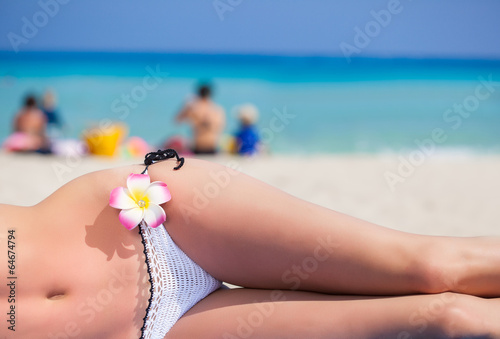 Photo: Woman's body is lying on the beach Woman's body is lying on the beach