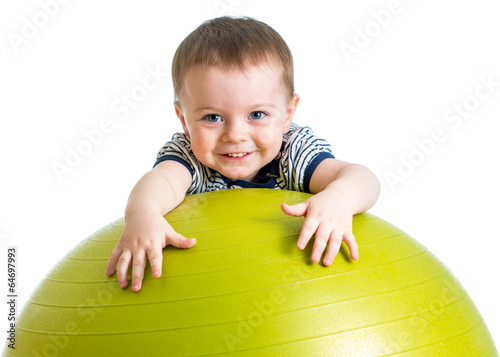 Photo: kid girl doing fitness exercise with fitness ball kid girl doing fitness exercise with fitness ball