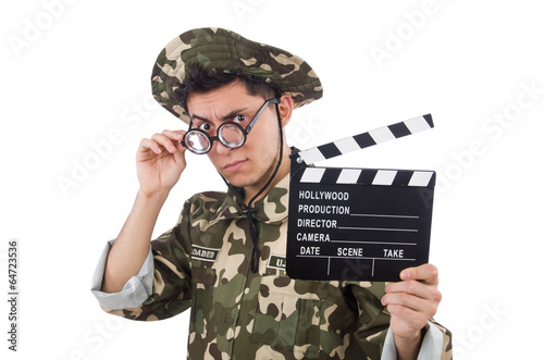 Photo: Funny soldier with movie board isolated on the white Funny soldier with movie board isolated on the white