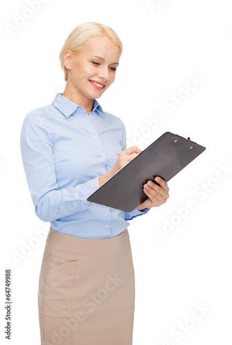 Photo: smiling businesswoman with clipboard and pen smiling businesswoman with clipboard and pen