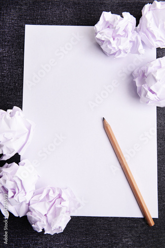 Photo: Sheet of white paper with crumpled paper and pencil Sheet of white paper with crumpled paper and pencil