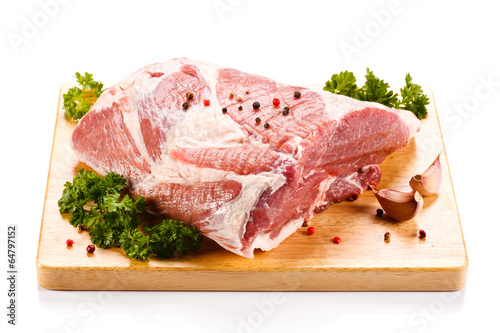 Photo: Fresh raw pork on cutting board on white background Fresh raw pork on cutting board on white background