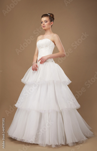 Photo: Elegance. Young Lady in Long Classic Bridal Dress Elegance. Young Lady in Long Classic Bridal Dress