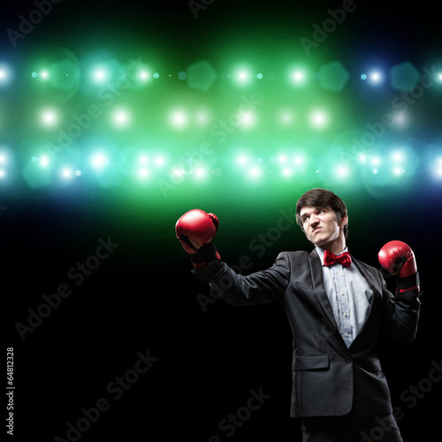 Photo: businessman with boxing gloves in the ring businessman with boxing gloves in the ring
