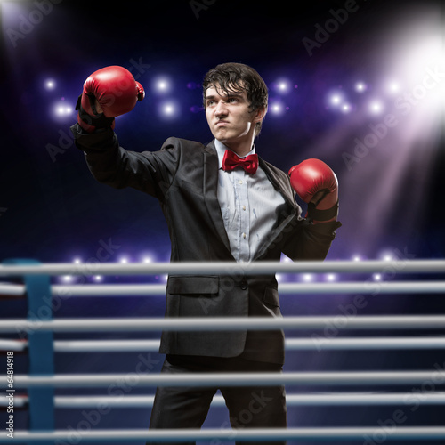 Photo: businessman with boxing gloves in the ring businessman with boxing gloves in the ring