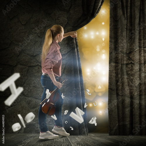 Photo: young woman pushes the curtain young woman pushes the curtain