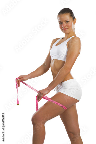 Photo: athletic woman measuring thigh athletic woman measuring thigh