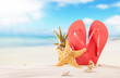 Summer beach with red sandals and shells Summer beach with red sandals and shells