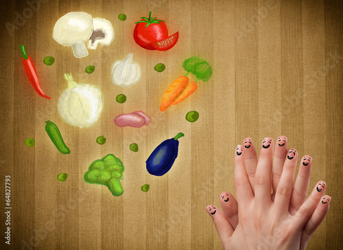 Photo: Happy smiley face fingers looking at illustration of colorful he Happy smiley face fingers looking at illustration of colorful he