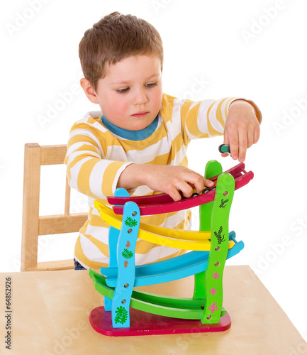 Photo: little boy playing at the table little boy playing at the table