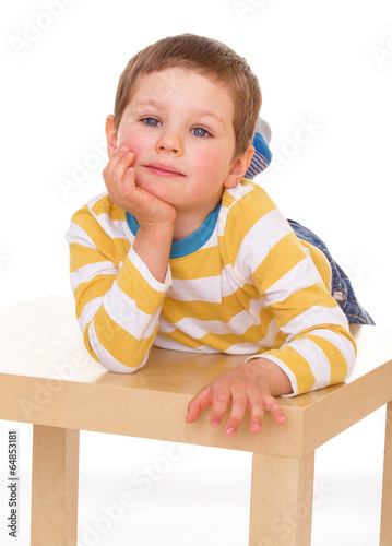 Photo: little boy playing at the table little boy playing at the table