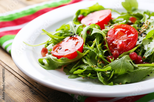 Photo: Green salad made with arugula, tomatoes and sesame Green salad made with arugula, tomatoes and sesame