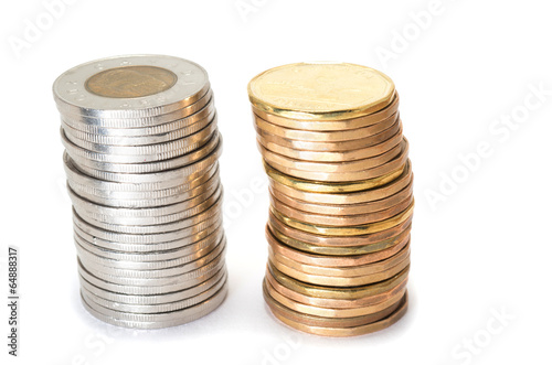 Photo: Silver and brass coins stack on white background Silver and brass coins stack on white background