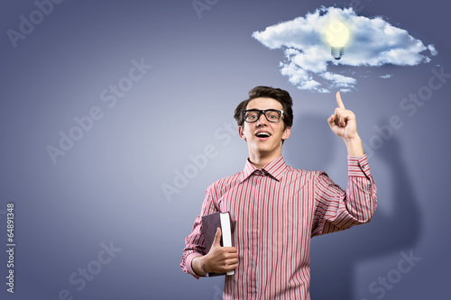 Photo: young man holding a book young man holding a book