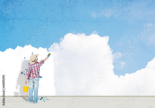 Photo: boy paints the wall boy paints the wall