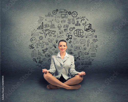 Photo: business woman meditating on floor business woman meditating on floor