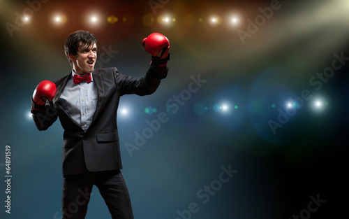 Photo: businessman with boxing gloves in the ring businessman with boxing gloves in the ring