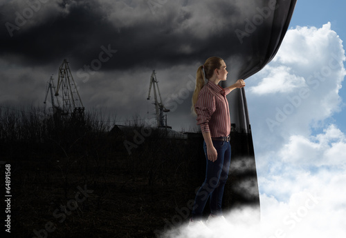 Photo: young woman pushes the curtain looking at clouds young woman pushes the curtain looking at clouds
