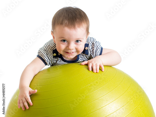 Photo: kid girl doing fitness exercise with fitness ball kid girl doing fitness exercise with fitness ball