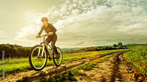  Sport bike woman on a meadow with a beautiful landscape