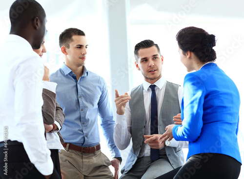 Photo: business partners discussing documents and ideas at meeting business partners discussing documents and ideas at meeting