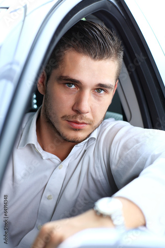 Photo: Handsome man in his new car and smiling at camera Handsome man in his new car and smiling at camera