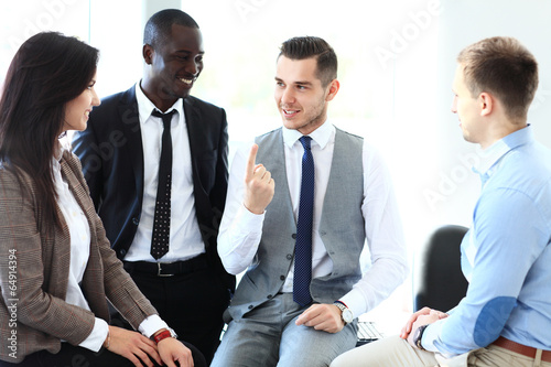 Photo: business partners discussing documents and ideas at meeting business partners discussing documents and ideas at meeting