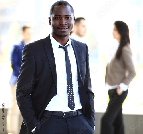 Photo: smiling African American business man with executives working smiling African American business man with executives working