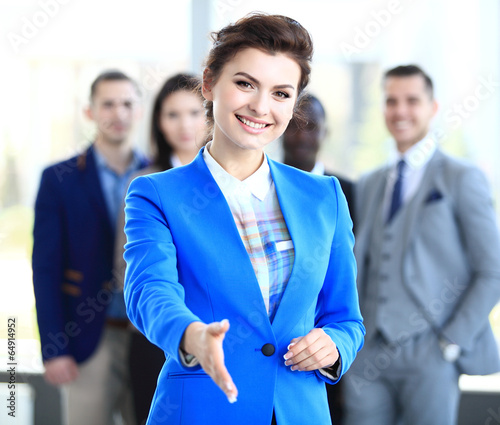 Photo: businesswoman with an open hand ready to seal a deal businesswoman with an open hand ready to seal a deal