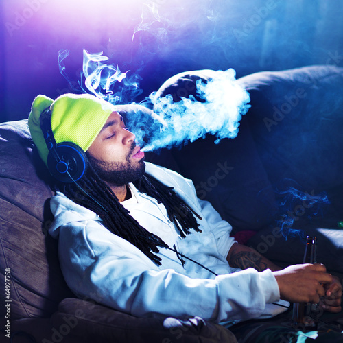 Photo: cool man smoking marijuana on his couch cool man smoking marijuana on his couch