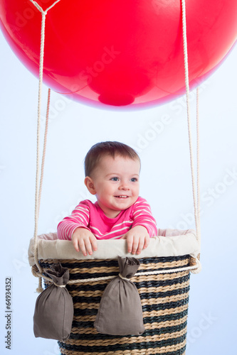 Photo: kid on hot air balloon in the sky kid on hot air balloon in the sky