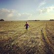 girl running through summer field girl running through summer field